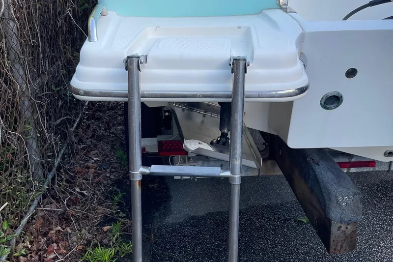 Slide: The Image of Rear view of 2006 Scout 242 Sportfish boat with ladder and trailer. - 44