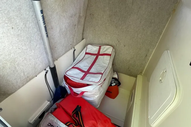 Slide: The Image of Interior storage of 2006 Scout 242 Sportfish boat with marine equipment and supplies. - 49