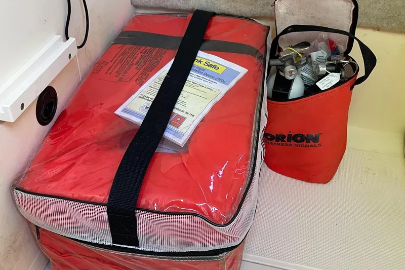 Slide: The Image of Safety equipment on a 2006 Scout 242 Sportfish, including life jackets and distress signals. - 50