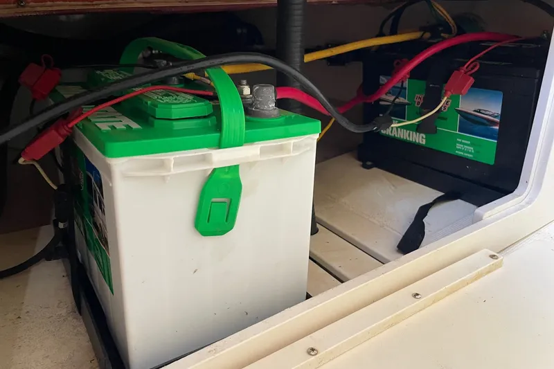 Slide: The Image of Batteries inside a 2006 Scout 242 Sportfish boat, showing wiring and connections. - 52