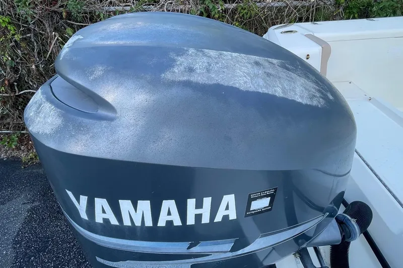 Slide: The Image of Yamaha outboard motor on 2006 Scout 242 Sportfish boat, showing wear and weathering. - 63