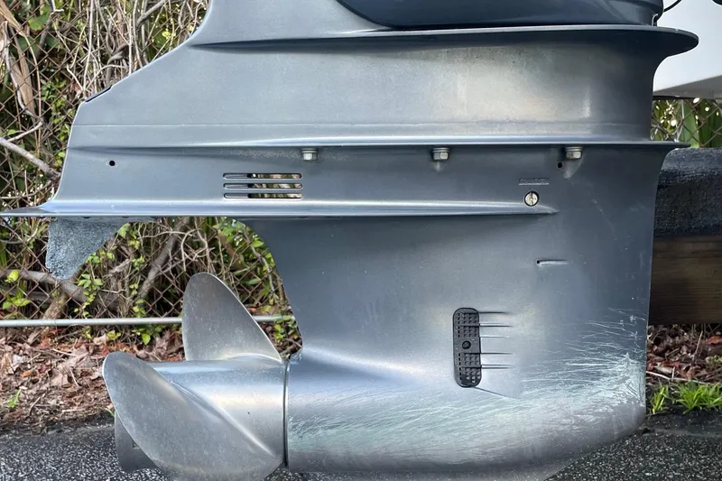 Slide: The Image of Close-up of a 2006 Scout 242 Sportfish outboard motor with visible wear. - 64