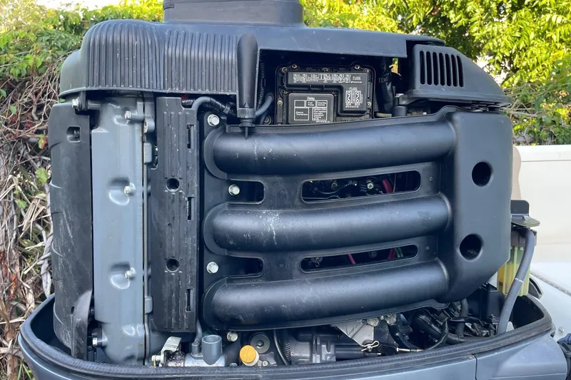 Slide: The Image of Close-up of a 2006 Scout 242 Sportfish outboard engine, showcasing internal components. - 65