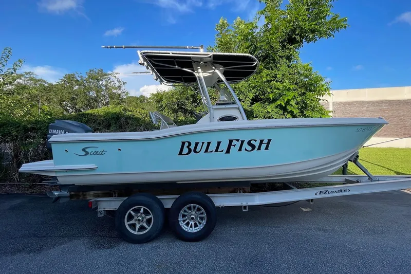 Slide: The Image of 2006 Scout 242 Sportfish boat on trailer, labeled "BullFish," with Yamaha engine. - 7