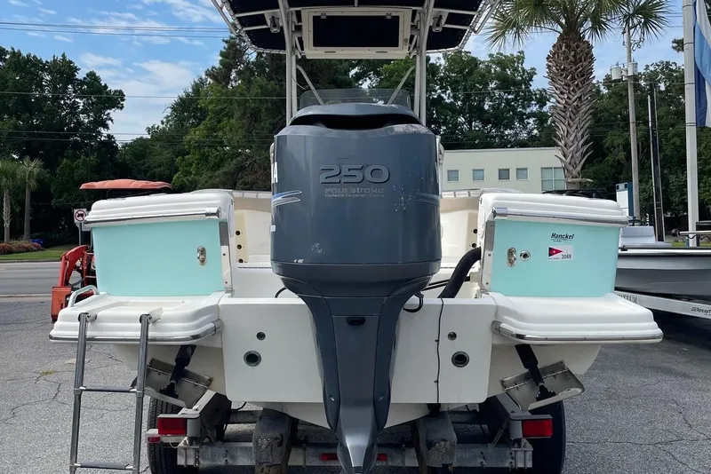 Slide: The Image of 2006 Scout 242 Sportfish boat with Yamaha 250 outboard motor, parked outdoors. - 9