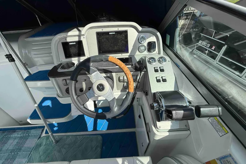 Slide: The Image of 2007 Formula 27 Performance Cruiser cockpit with steering wheel, controls, and navigation displays. - 11