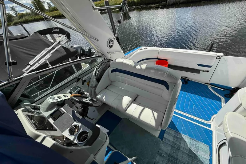 Slide: The Image of 2007 Formula 27 Performance Cruiser interior with white seating and blue flooring by the water. - 15