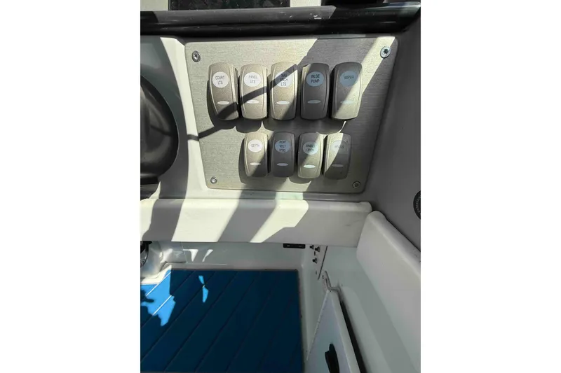 Slide: The Image of Control panel of a 2007 Formula 27 Performance Cruiser boat with labeled switches. - 18