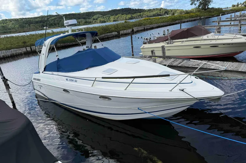 Slide: The Image of 2007 Formula 27 Performance Cruiser docked at a scenic lakeside marina. - 2