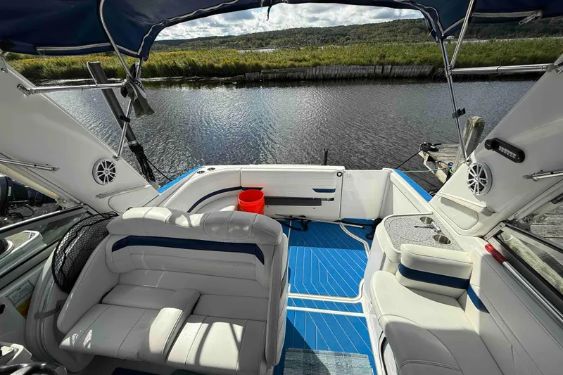 Slide: The Image of 2007 Formula 27 Performance Cruiser interior with blue flooring, white seating, and water view. - 25