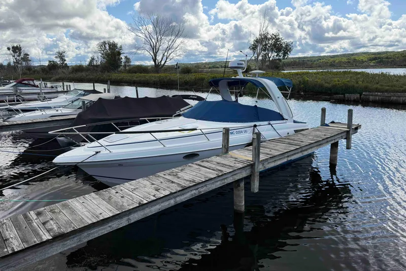 Slide: The Image of 2007 Formula 27 Performance Cruiser docked at a scenic marina under a cloudy sky. - 3