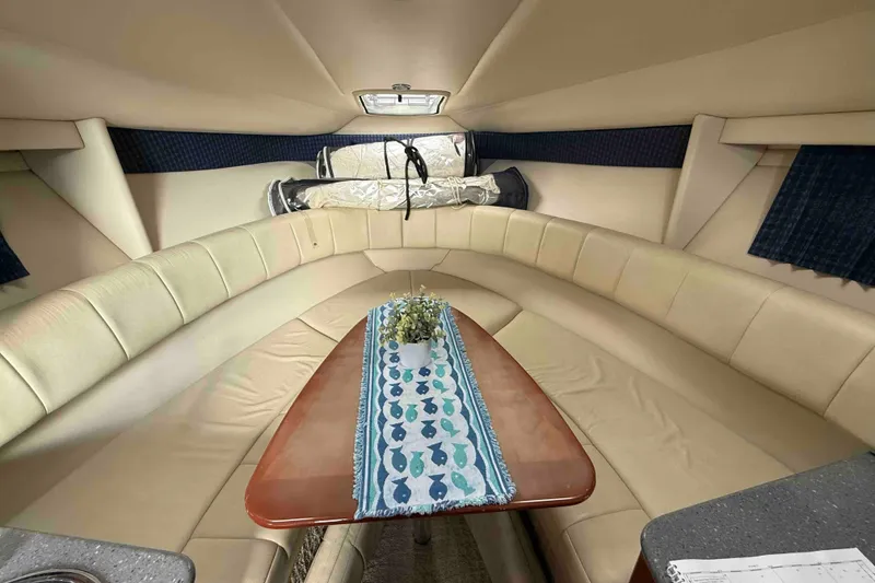 Slide: The Image of 2007 Formula 27 Performance Cruiser interior with beige seating and wooden table. - 36