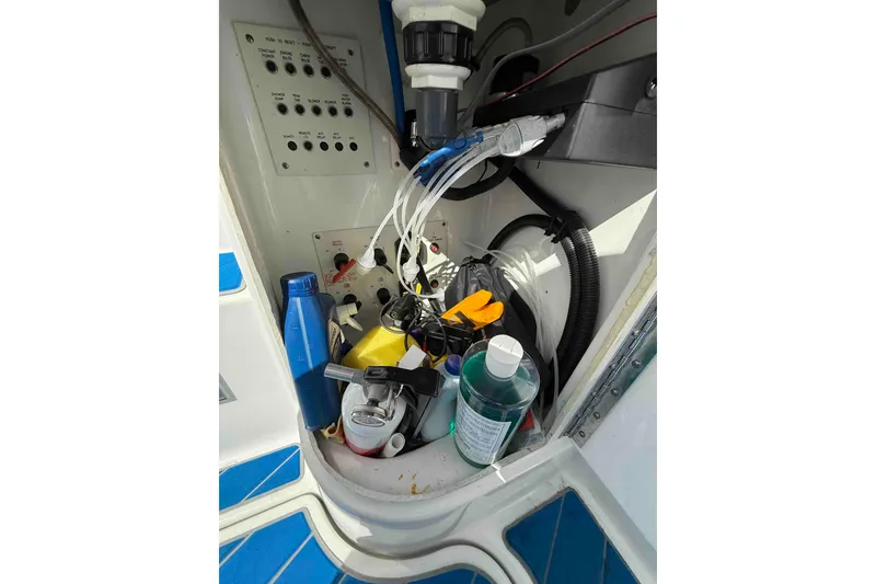 Slide: The Image of 2007 Formula 27 Performance Cruiser storage compartment with various maintenance supplies and cables. - 50