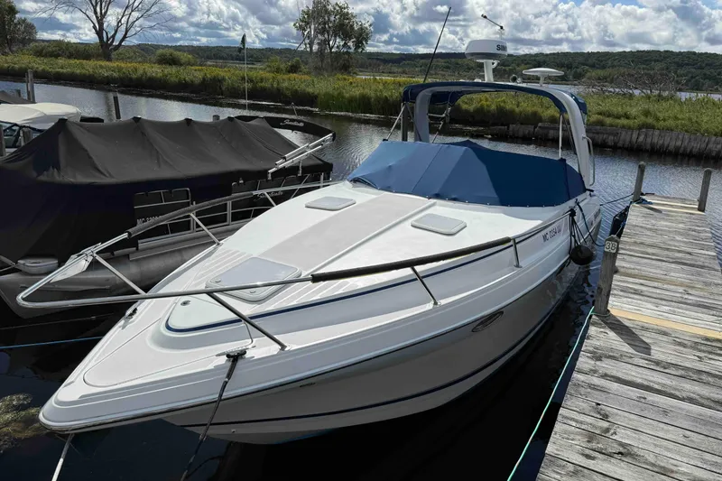 Slide: The Image of 2007 Formula 27 Performance Cruiser docked by a scenic lakeside. - 6