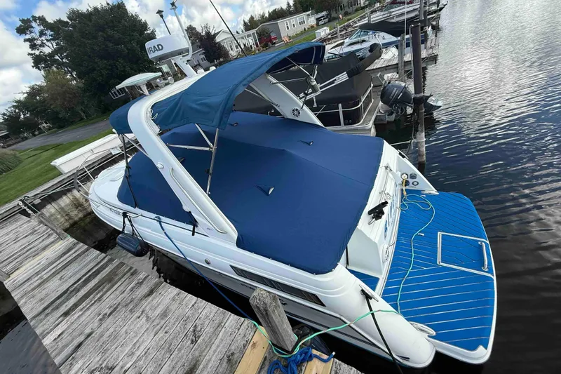 Slide: The Image of 2007 Formula 27 Performance Cruiser docked with blue cover and swim platform. - 7