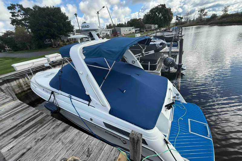 Slide: The Image of 2007 Formula 27 Performance Cruiser docked, featuring blue canopy and cover. - 9
