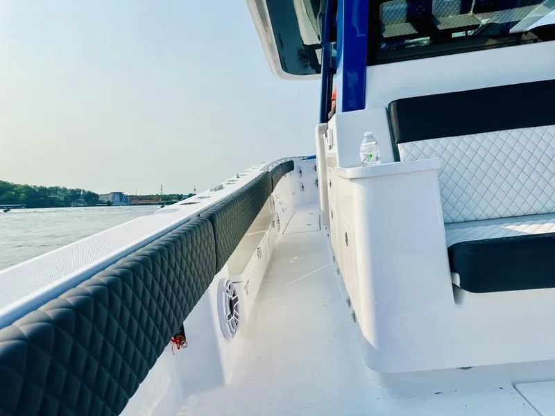 Slide: The Image of 2025 HCB 48 Campeon boat interior with luxurious seating and water view. - 10