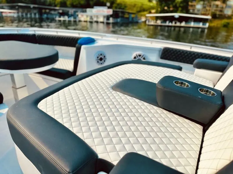 Slide: The Image of Luxurious seating on 2025 HCB 48 Campeon boat with quilted upholstery and cup holders. - 13