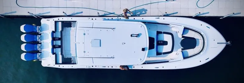 Slide: The Image of Aerial view of 2025 HCB 48 Campeon luxury boat docked with four engines. - 16