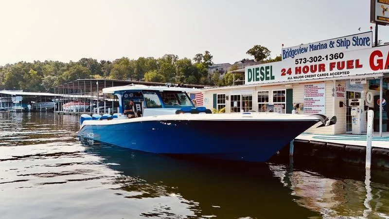 Slide: The Image of 2025 HCB 48 Campeon boat docked at marina with fuel station. - 18
