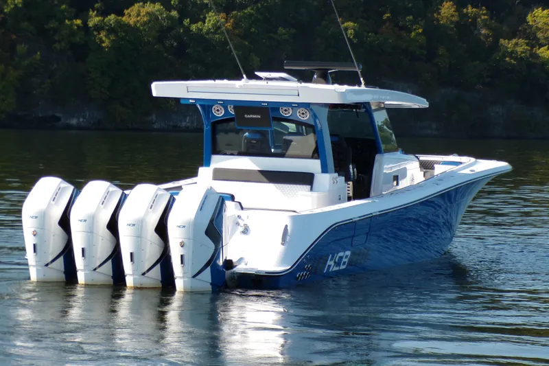 Slide: The Image of 2025 HCB 48FT Campeon boat with four engines on a calm lake. - 5