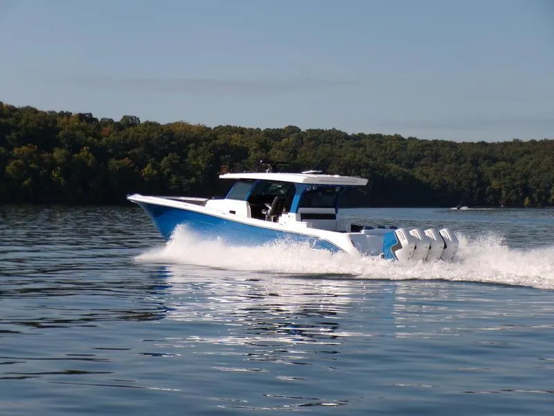 Slide: The Image of 2025 HCB 48 Campeon boat cruising on a calm lake. - 6