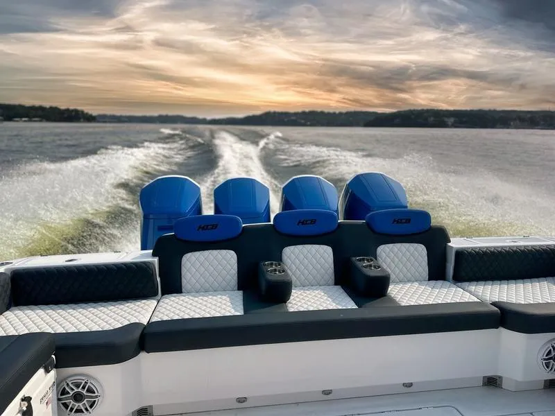 Slide: The Image of 2025 HCB 48 Campeon boat with powerful engines cruising at sunset. - 8