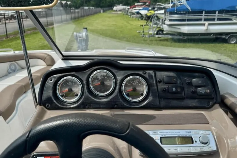 Slide: The Image of 2011 Yamaha Boats SX240 HO dashboard with gauges and controls, steering wheel visible. - 8