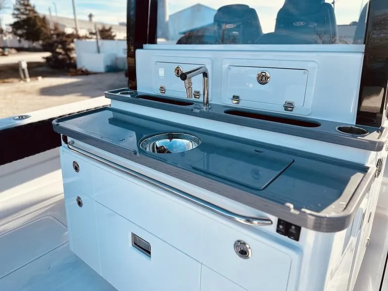 Slide: The Image of 2024 HCB 42 Lujo boat galley with sink and storage compartments. - 11