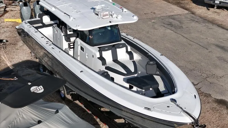 Slide: The Image of 2024 HCB 42 Lujo luxury center console boat docked on land. - 4