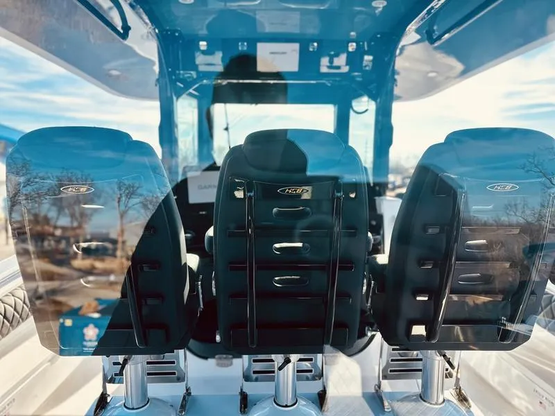 Slide: The Image of 2024 HCB 42 Lujo boat interior with three black seats. - 8