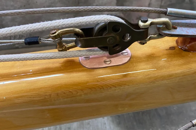 Slide: The Image of Close-up of 1974 Herreshoff Rozinante sailboat rigging and polished wooden mast. - 40