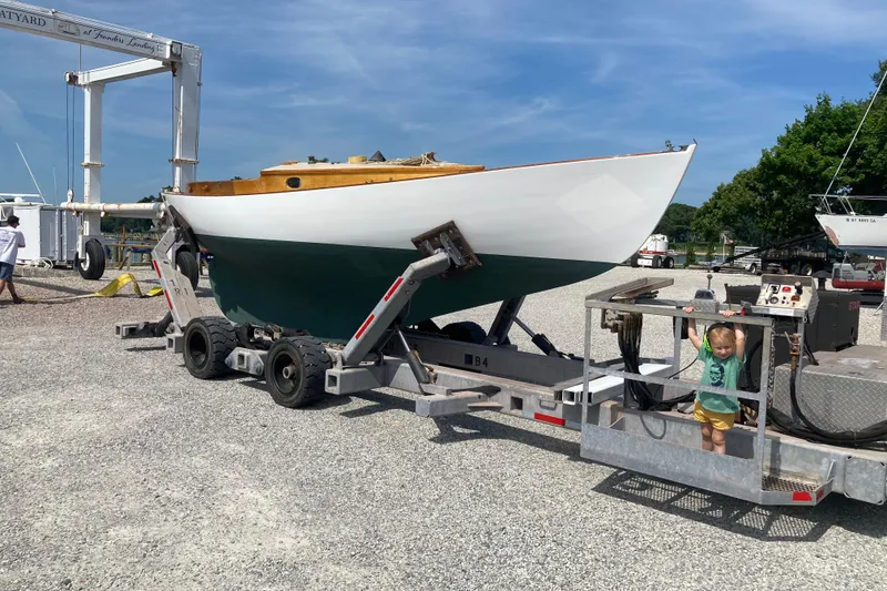 Slide: The Image of 1974 Herreshoff Rozinante sailboat on trailer at boatyard, sunny day. - 25