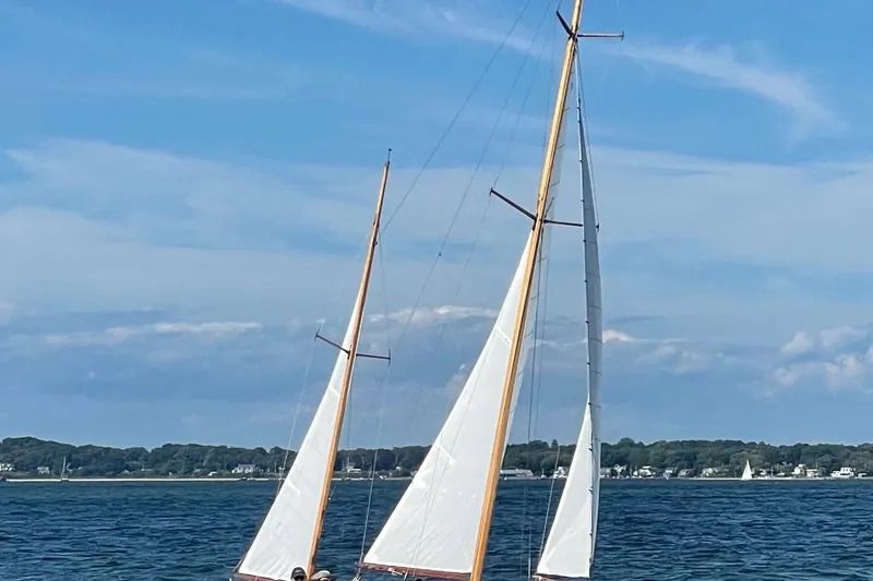 Slide: The Image of Sailing yacht Herreshoff Rozinante 1974 on open water under clear blue sky. - 11