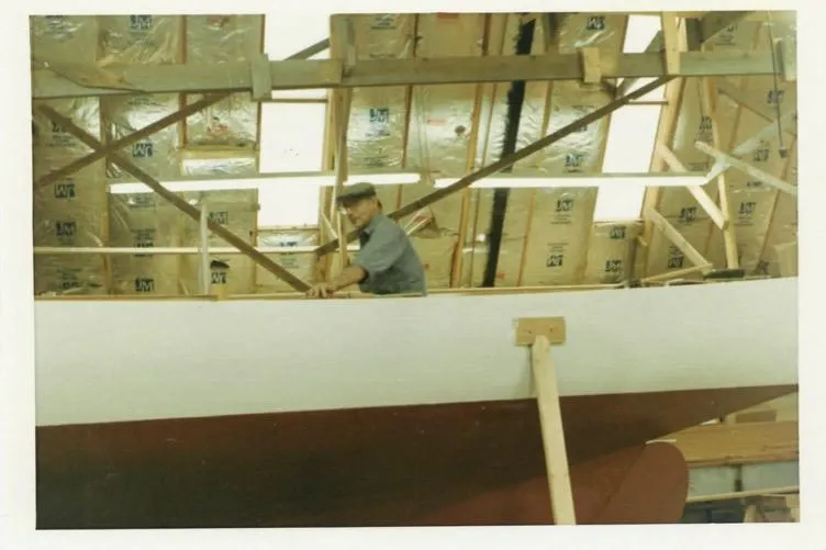 Slide: The Image of Man working on 1974 Herreshoff Rozinante boat construction indoors. - 66