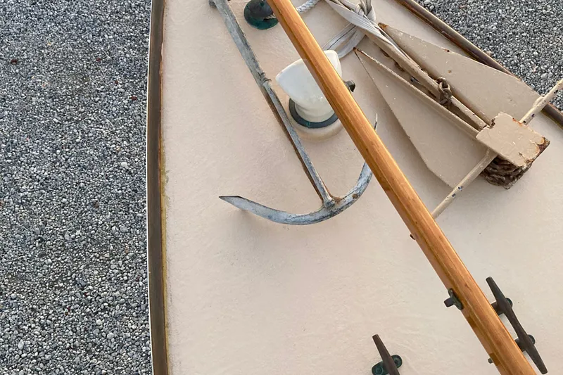 Slide: The Image of Bow of 1974 Herreshoff Rozinante sailboat with anchor and wooden mast. - 33