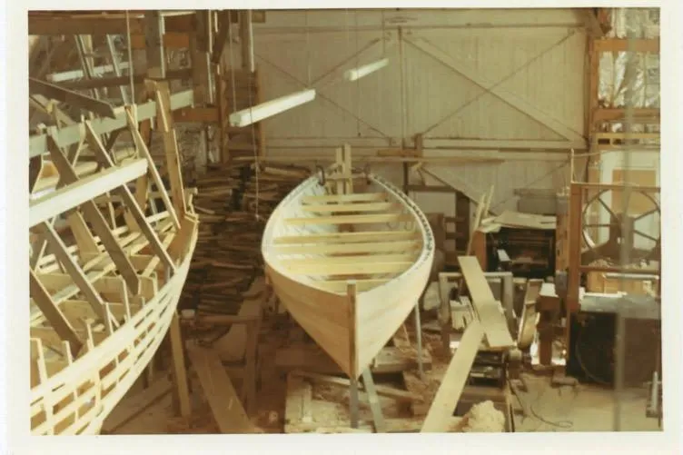 Slide: The Image of 1974 Herreshoff Rozinante sailboat under construction in a workshop. - 72