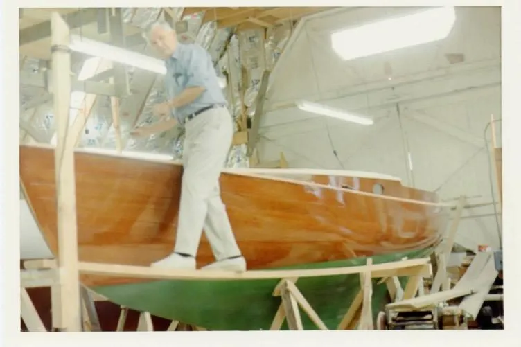 Slide: The Image of Man working on a 1974 Herreshoff Rozinante sailboat in a workshop. - 71