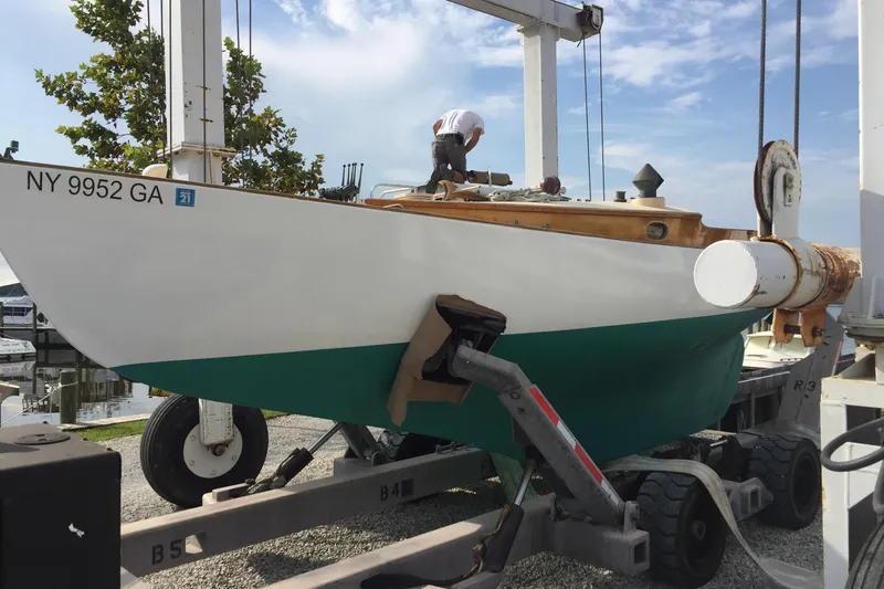 Slide: The Image of 1974 Herreshoff Rozinante sailboat on trailer, undergoing maintenance at a marina. - 28