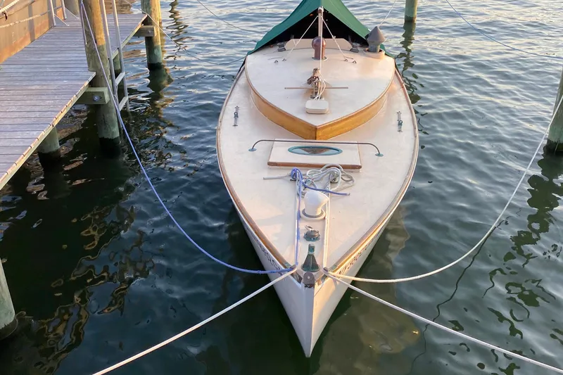 Slide: The Image of 1974 Herreshoff Rozinante sailboat docked on calm water, viewed from above. - 18