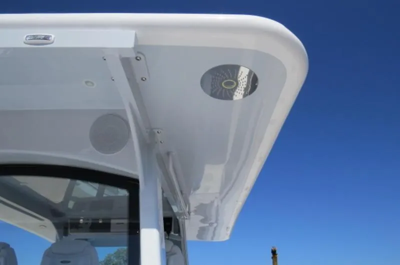 Slide: The Image of 2024 HCB 53 FT Suenos boat roof detail against clear blue sky. - 10