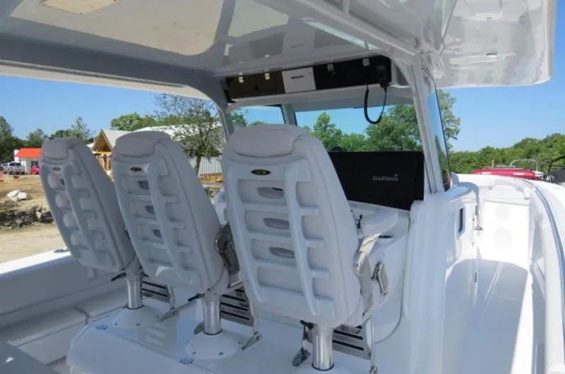 Slide: The Image of 2024 HCB 53 FT Suenos boat interior with white seating and navigation equipment. - 14