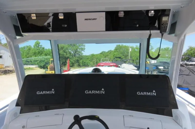 Slide: The Image of 2024 HCB 53 FT Suenos dashboard with Garmin displays and Mercury equipment. - 19