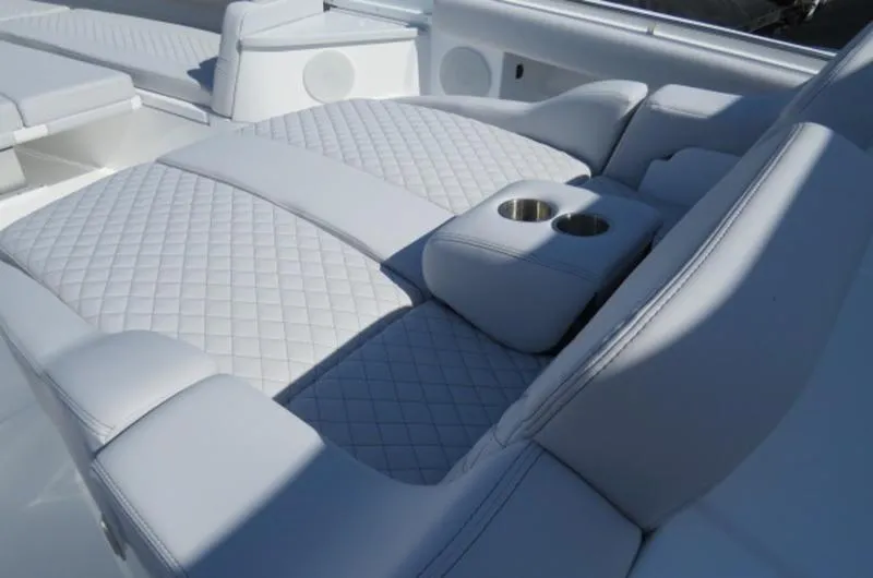 Slide: The Image of Luxurious seating on 2024 HCB 53 FT Suenos boat with quilted upholstery and cup holders. - 22