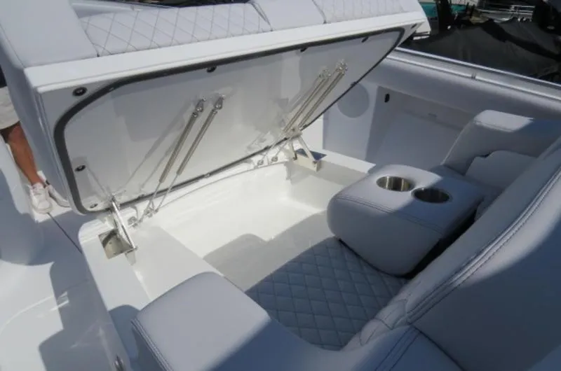 Slide: The Image of 2024 HCB 53 FT Suenos boat interior with open storage and cup holders. - 24