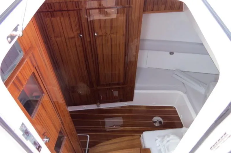 Slide: The Image of 2024 HCB 53 FT Suenos cabin interior with wooden cabinetry and flooring. - 25