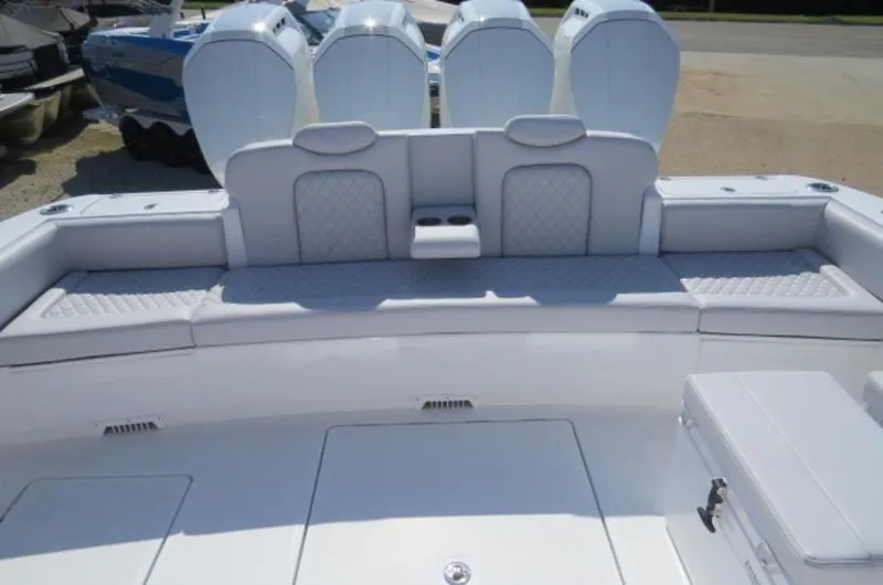 Slide: The Image of 2024 HCB 53 FT Suenos boat interior with cushioned seating and quad engines. - 3