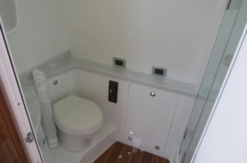 Slide: The Image of 2024 HCB 53 FT Suenos boat bathroom with modern fixtures and wooden flooring. - 32