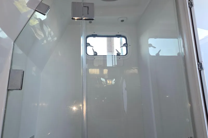 Slide: The Image of Interior view of 2024 HCB 53 FT Suenos boat cabin with window and glass door. - 39