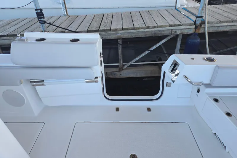 Slide: The Image of 2024 HCB 53 FT Suenos boat deck with open side door near dock. - 44